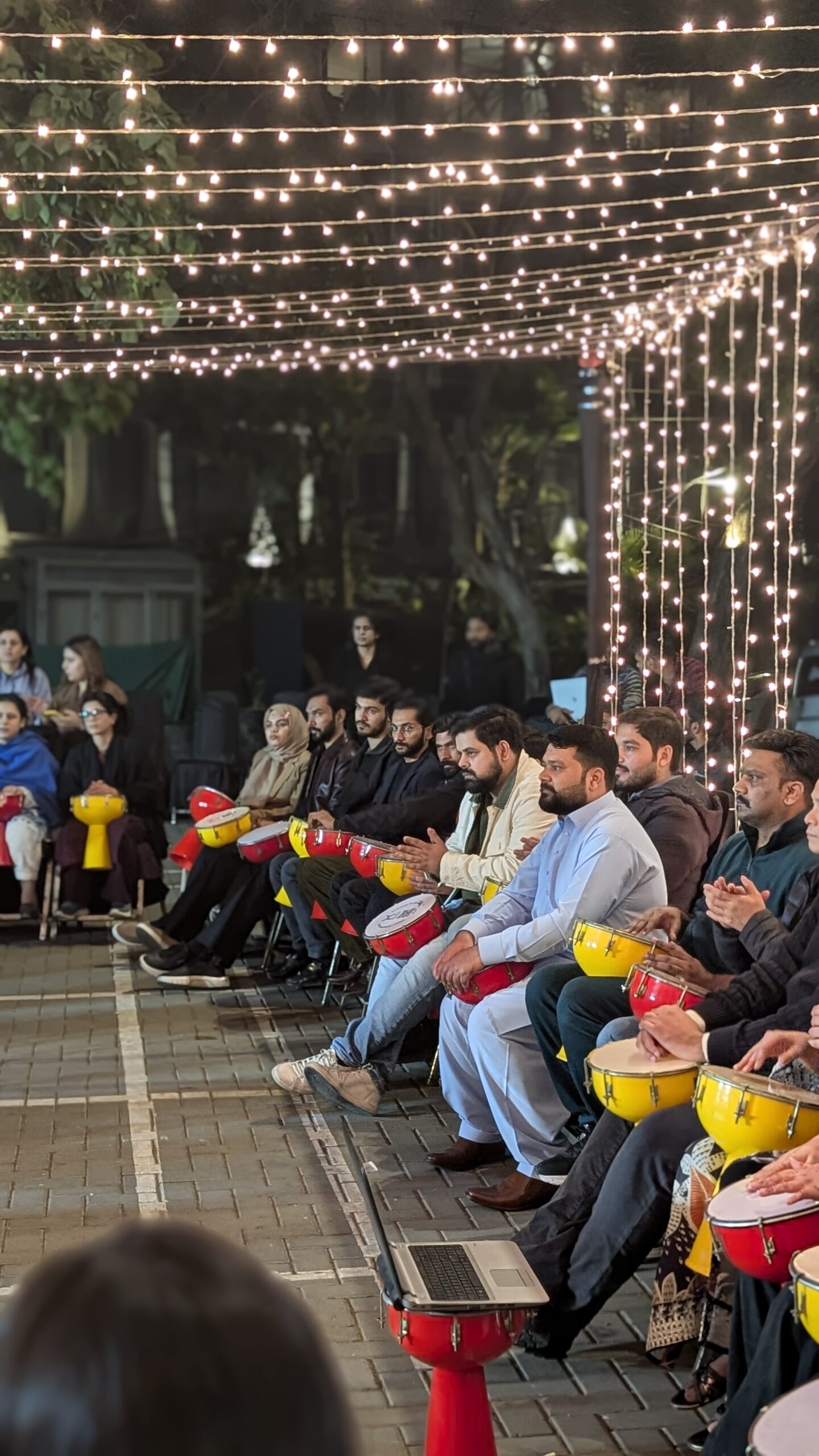 Energetic drum circle session at QuickOffice, 29-D Main Gulberg, where professionals connect through interactive group drumming.